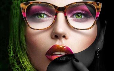 یک خانم عینک چشم سبز و عینکی که آرایش قشنگی دارد